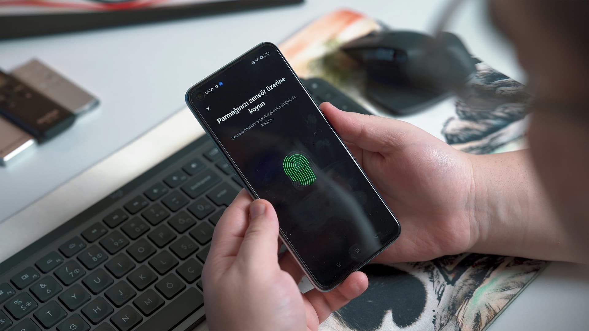 A hand unlocking a phone with a fingerprint sensor instead of a password