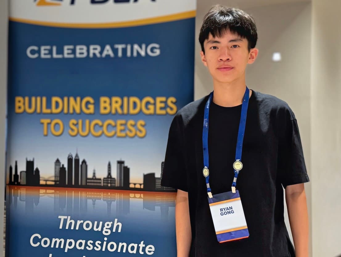 Ryan Gong, Founder of Enablet, in front of event banner